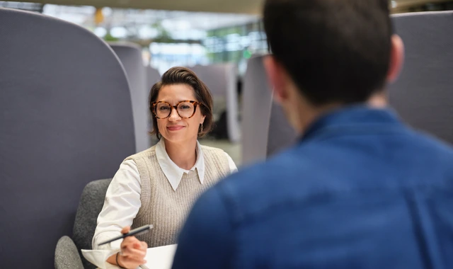 Professional woman smiling in office meeting