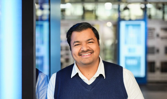 Smiling factory worker holding clipboard