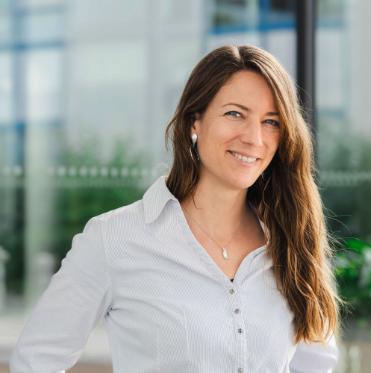 Smiling woman in white shirt at office