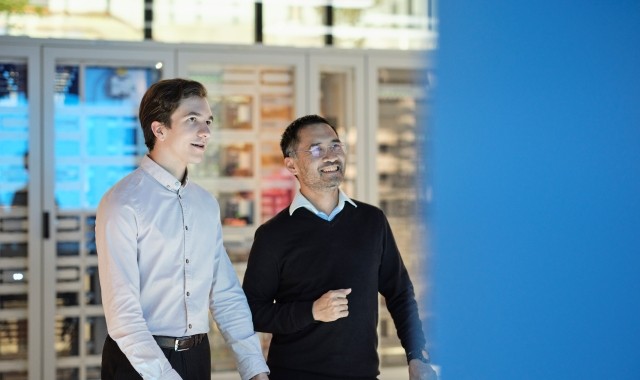Two colleagues viewing interactive display