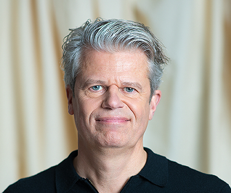 Man with short gray hair in dark shirt