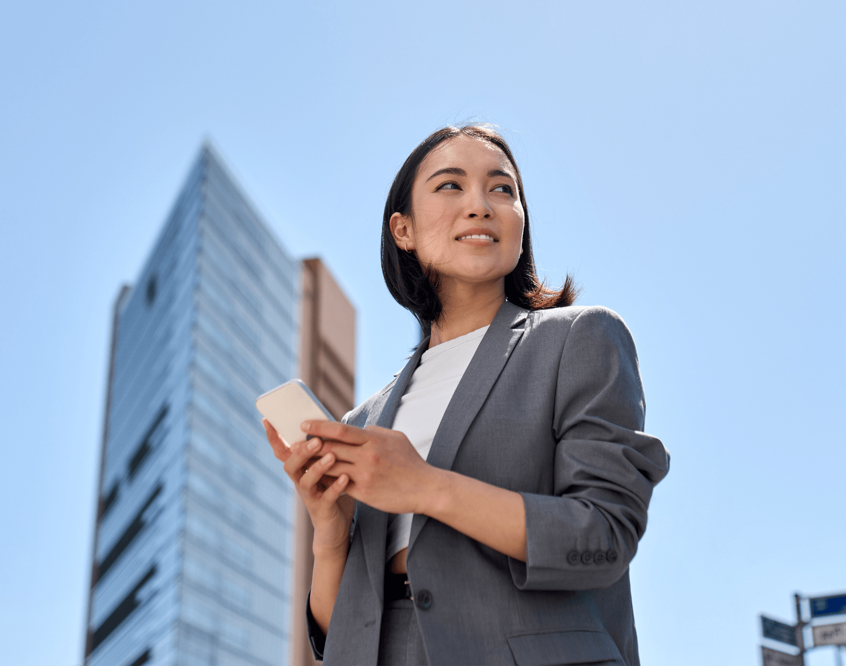 A professional standing outdoors, looking ahead.
