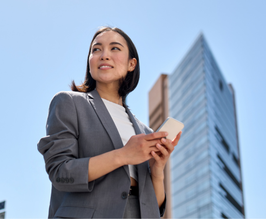 A professional smiling outside of the office.