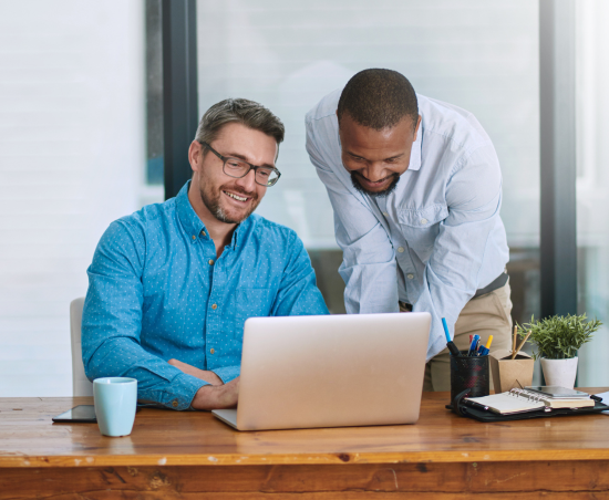 Two colleagues working together in an office setting.