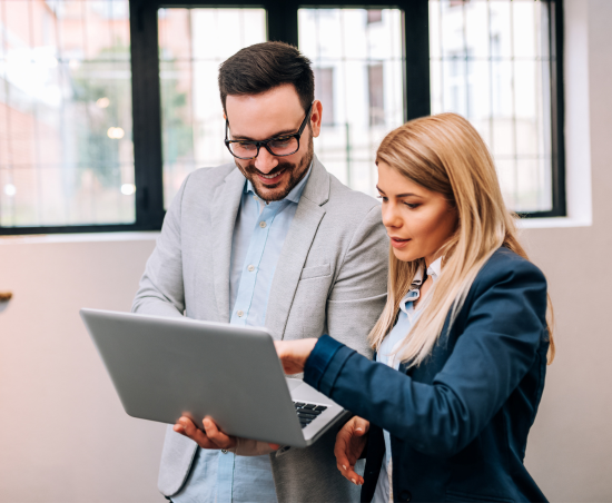 Two colleagues working together in an office setting.