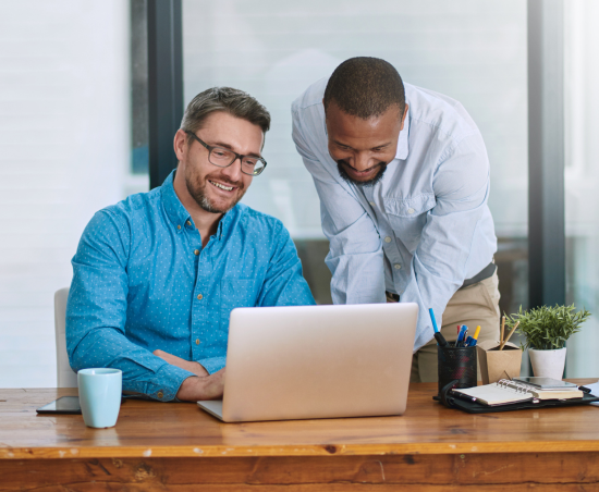 Two colleagues sat together within a professional environment.