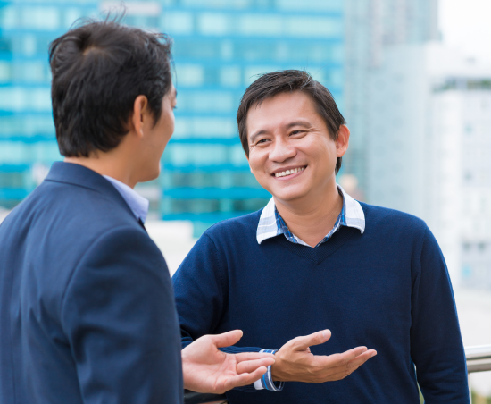Two colleagues engaged in conversation outside of the office.