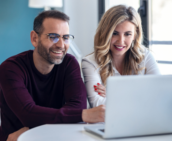 Two colleagues working together in an office setting.