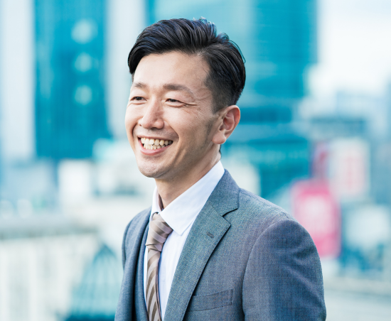 A professional smiling outside of the office.