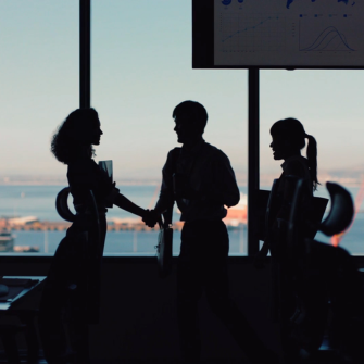 A group of professionals in a workplace setting, reflecting a collaborative work environment.