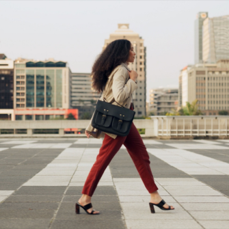 A professional standing outdoors, looking ahead.