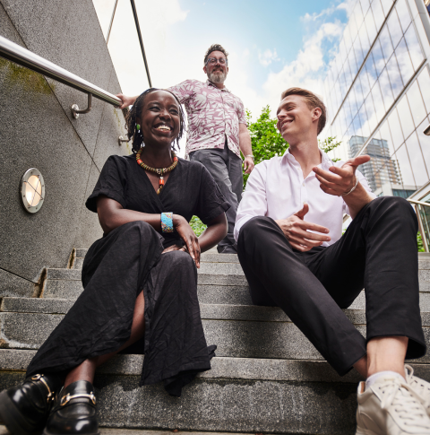 A group of colleagues engaged in conversation outside of the office.
