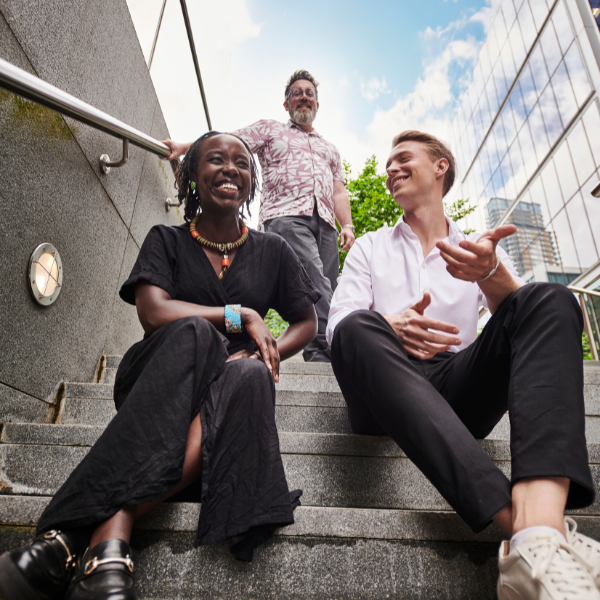 A group of colleagues engaged in conversation outside of the office.