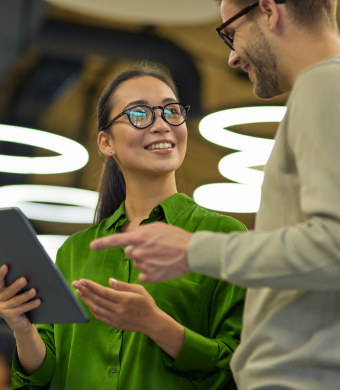 Two colleagues working together in an office setting.