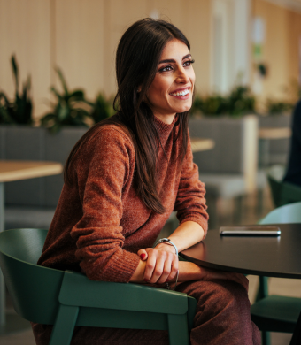 A professional smiling in a working environment.