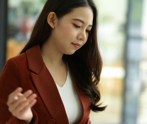 A professional in a modern office holding a book.
