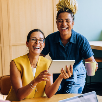 Two colleagues working together in an office setting.