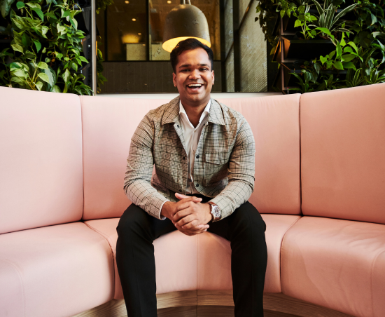A professional smiling in a working environment.