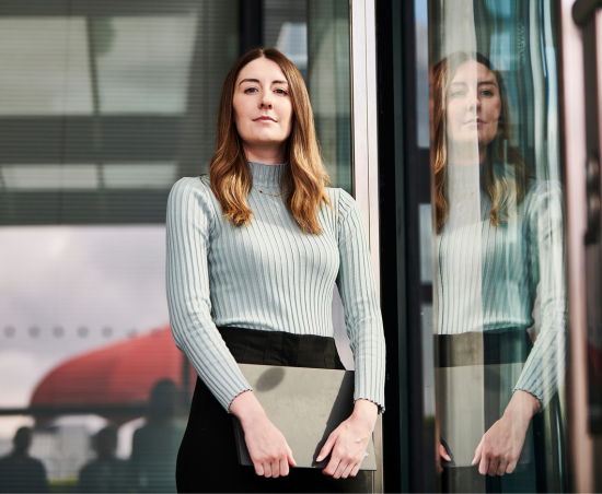 A professional looking out of the office window.