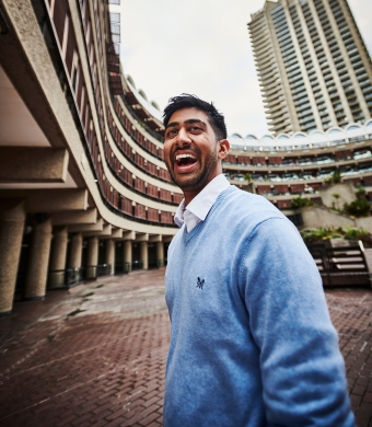 A professional smiling outside of the office.