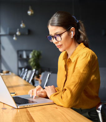 A professional working on a laptop.