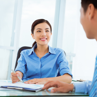 Two colleagues engaged in conversation in the office.