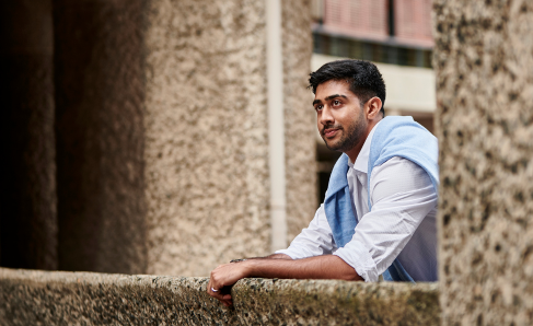 A professional outside of the office, looking into the distance.