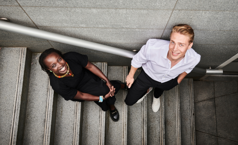 Two colleagues working together in an office setting.