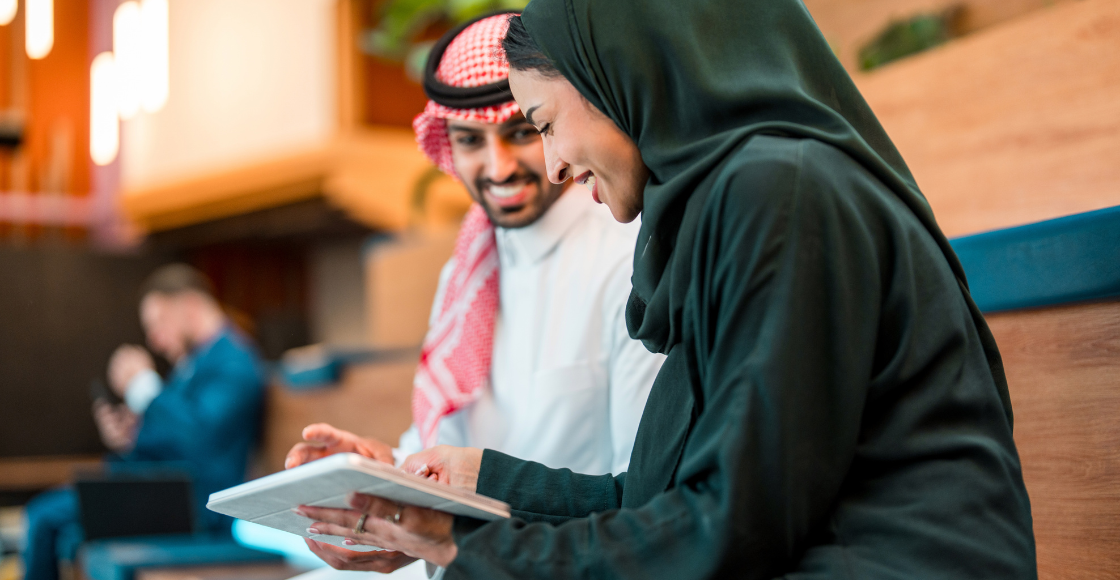 Two colleagues working together in an office setting.