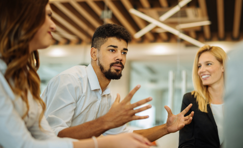 A group of professionals in a workplace setting, reflecting a collaborative work environment.