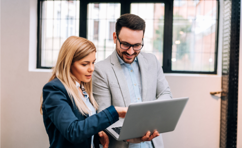Two colleagues working together in an office setting.