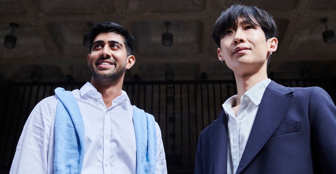 Two professionals stood outside of the office environment.