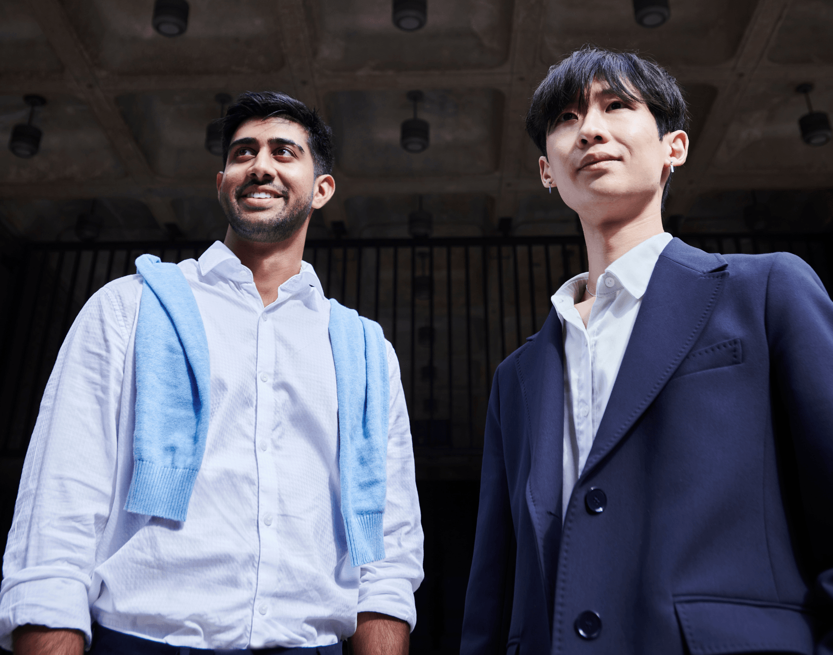 Two professionals stood outside of the office environment.