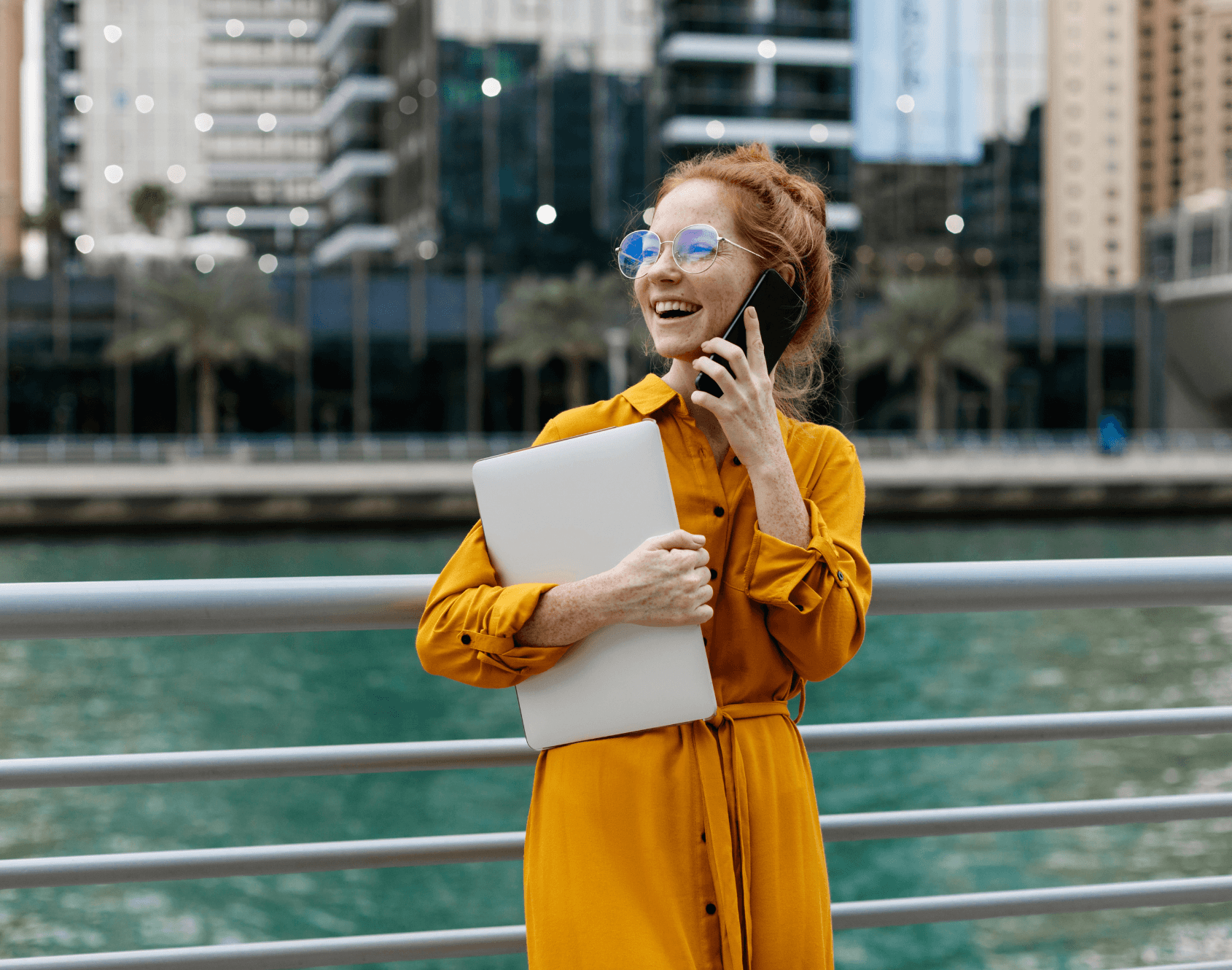 A professional smiling outside of the office.