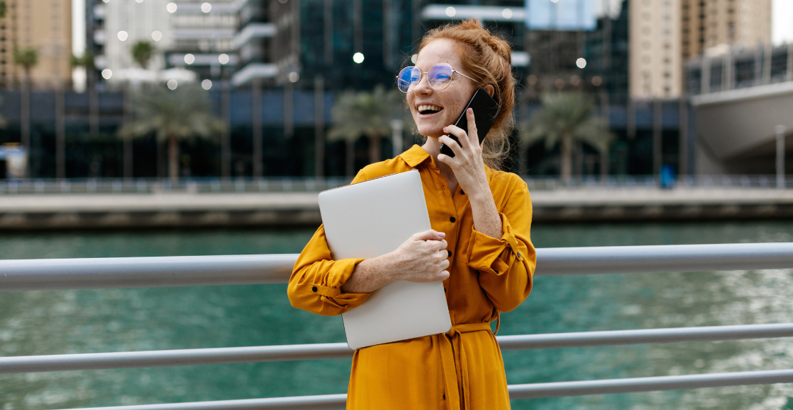 A professional smiling outside of the office.