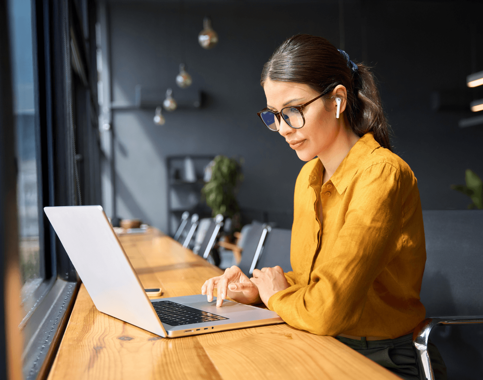 A professional working on a laptop.