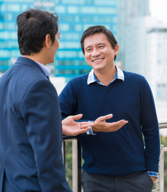 Two colleagues engaged in conversation outside of the office.