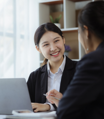 Two professionals working together in an office setting.