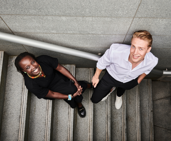Two professionals stood outside of the office environment.
