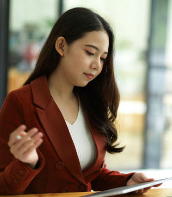 A professional in a modern office holding a notebook.