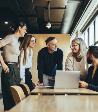 A group of professionals in a workplace setting, reflecting a collaborative work environment.