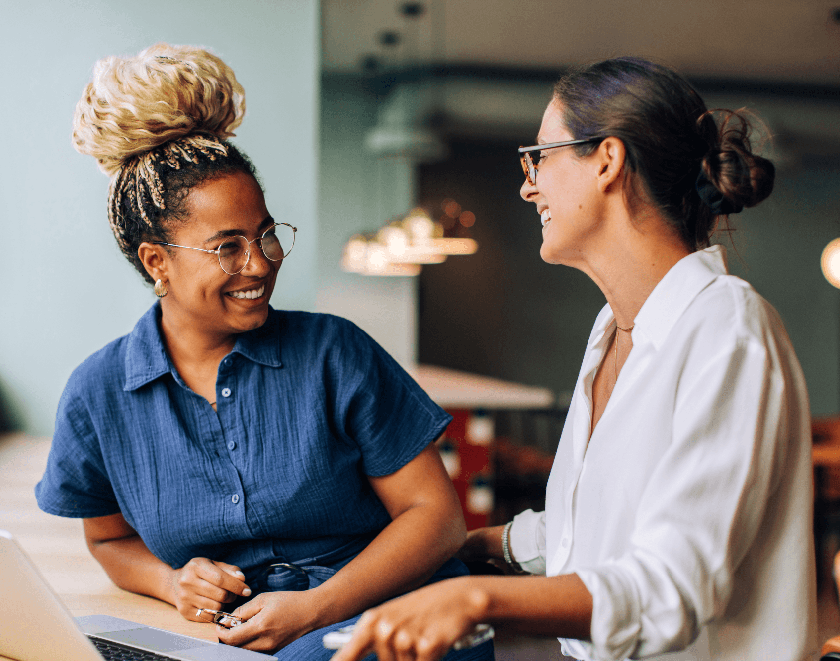 Two colleagues working together in an office setting.
