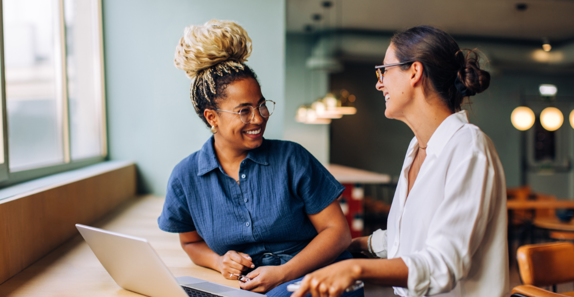 Two colleagues working together in an office setting.