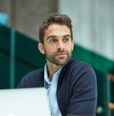 A professional working on a laptop.
