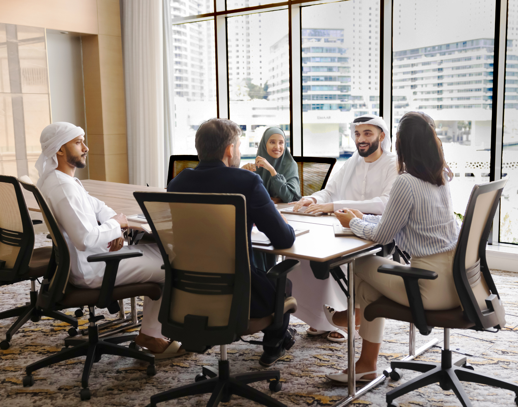 A group of professionals in a workplace setting, reflecting a collaborative work environment.