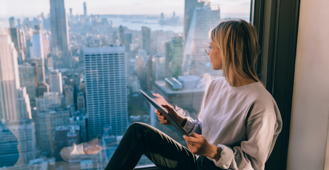 A professional looking out at the view from the office.