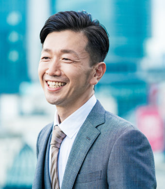 A professional smiling outside of the office.