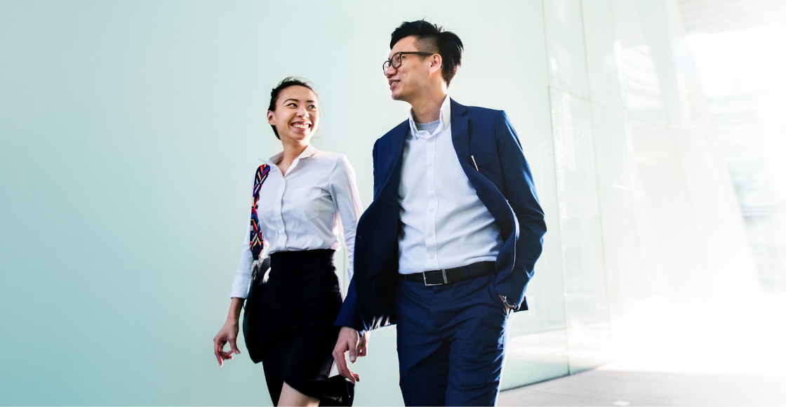 Two colleagues engaged in conversation outside of the office.