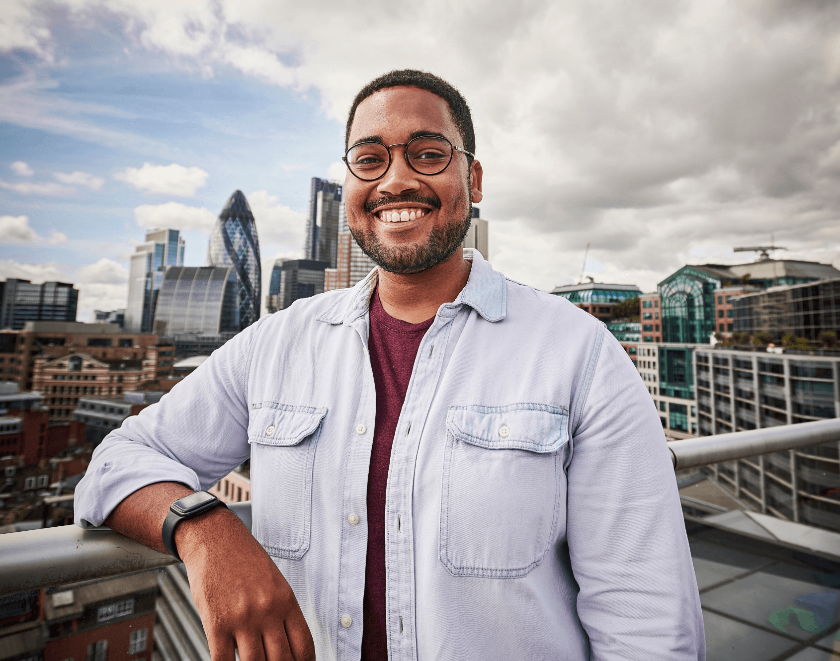 A professional smiling outside of the office.