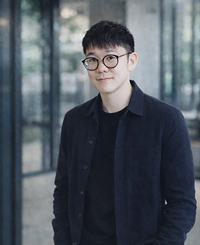 Portrait of person with glasses in office hallway